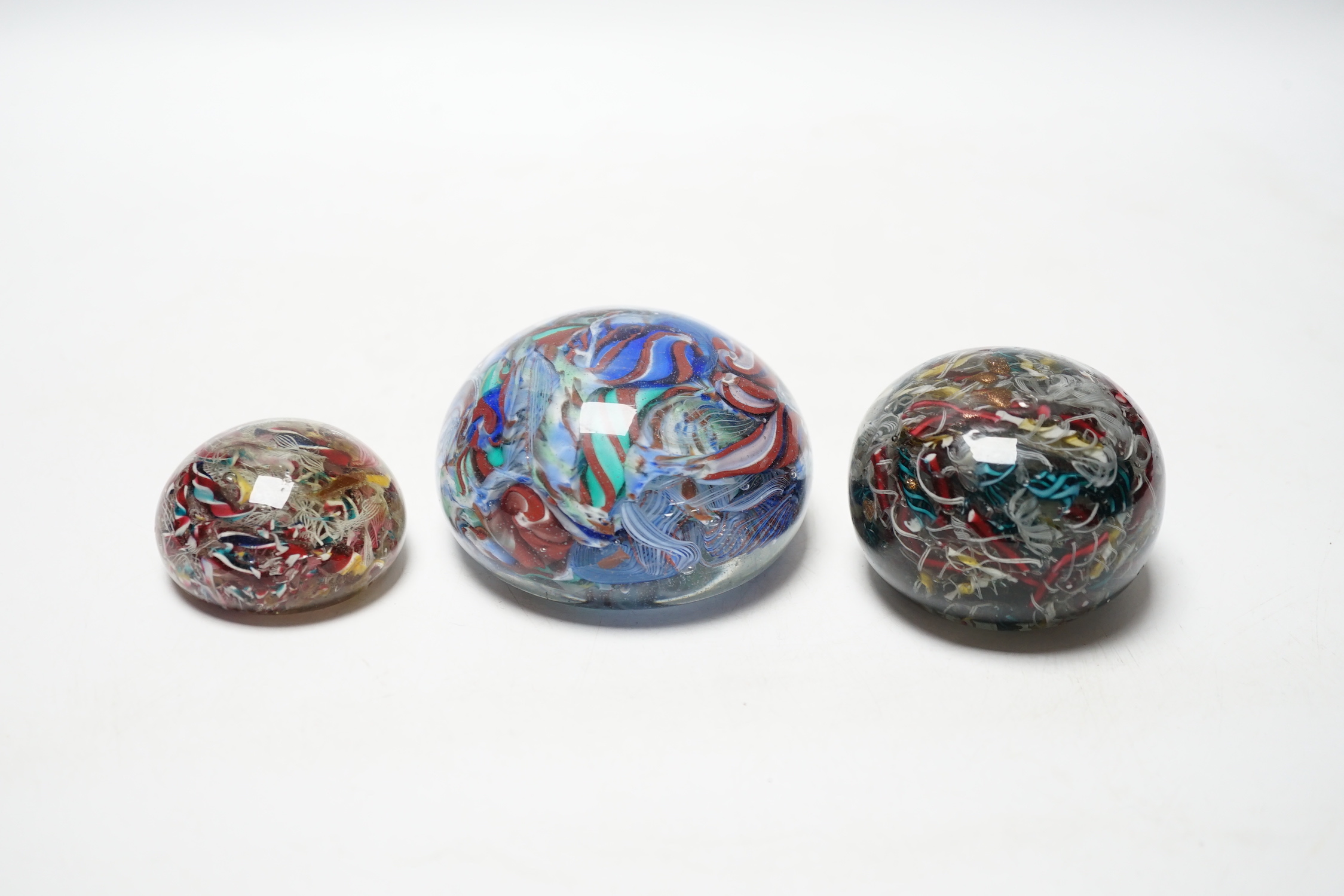 Three 19th century Venetian scrambled glass paperweights, largest 8.5cm